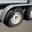 The Back Of A Towing Trailer With Extremely Worn Tread That Is Falling Off And In Need Of Repair