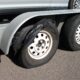 The Back Of A Towing Trailer With Extremely Worn Tread That Is Falling Off And In Need Of Repair